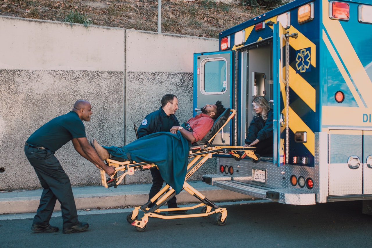 A guy being carried to an ambulance